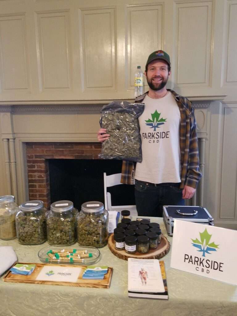 Vendor with a giant bag of hemp at Hemp Market cbd